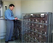 man with a clipbaord near a wall unit